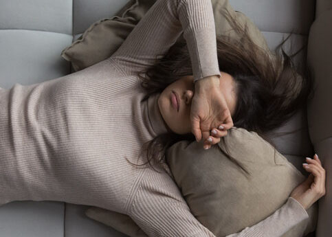 Peaceful girl lying on back on comfortable couch at home